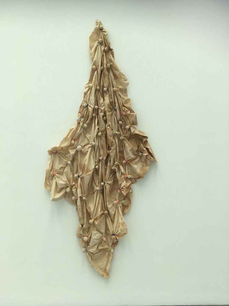 Veronica Ryan. Hang, 2020. Stained cotton sheet, avocado stones, hairbands, 224 x 106 x 1.5 cm.
