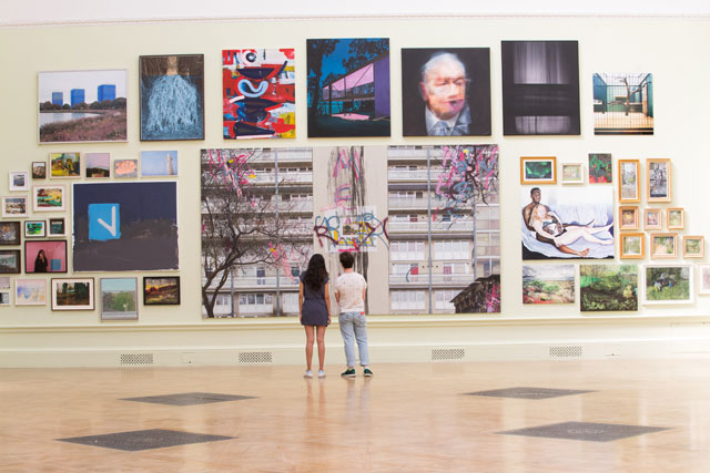 Installation view of Gallery III hung by Jock Mcfadden. Large painting in centre is David Hepher, Hey Wayne on the Meath Estate. Acrylic, oil, spray paint and concrete. Photo: © David Parry/ Royal Academy of Arts.