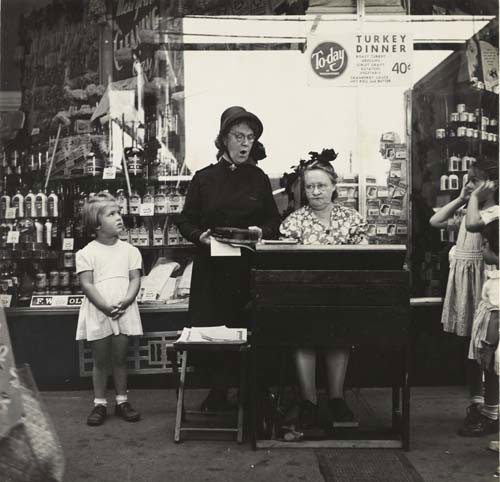 Lee Sievan. <em>Salvation Army Lassie in Front of a Woolworth Store</em>, c1940. Gelatin silver print. The Jewish Museum, New York, Purchase: Horace W. Goldsmith Foundation Fund. © Estate of Lee Sievan.