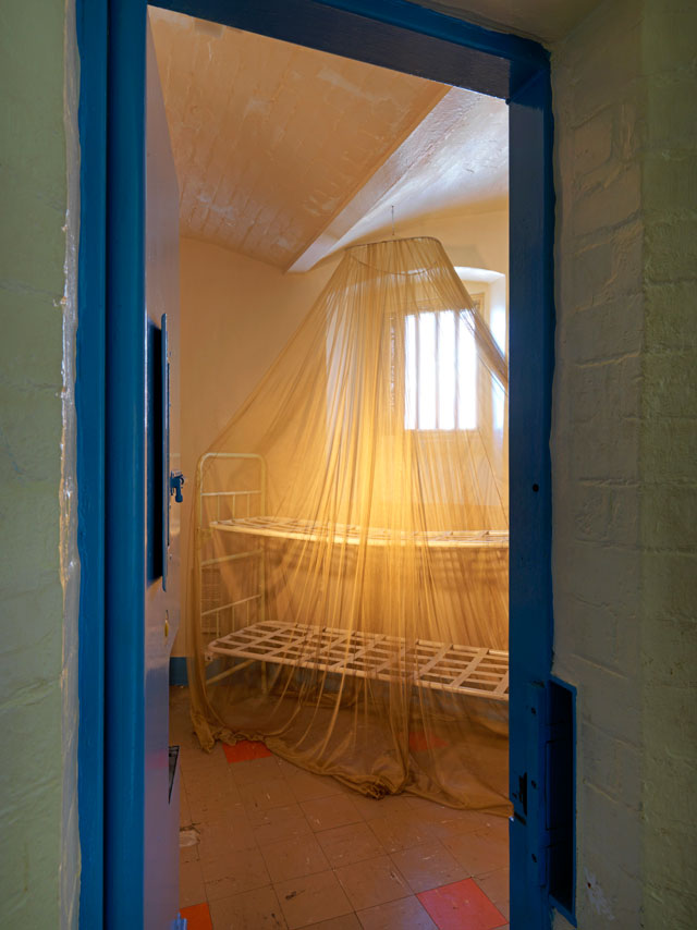 Steve McQueen, The Weight, 2016. Gold-plated mosquito net draped over a prison-issue bunkbed. Photograph: © Marcus J. Leith. Courtesy of Artangel.