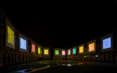 Clifford Ross. Nighttime view of immersive Harmonium Mountain video. Courtyard D. MASS MoCA.