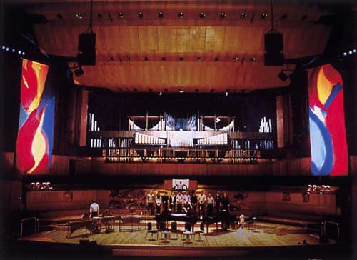 Mark Rowan-Hull. Performance with complementary lighting. Paintings inspired by Messe de la Pentecôte by Olivier Messiaen. Royal Festival Hall 2002.