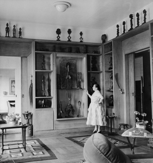 Helena Rubinstein in the library of her Paris apartment on the Ile St.-Louis, 1951. On display is a fraction of her extraordinary collection of African and Oceanic art. Helena Rubinstein Foundation Archives, Fashion Institute of Technology, SUNY, Gladys Marcus Library, Special Collections