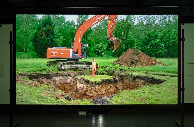 Regina José Galindo, Tierra, 2013. Colour video, with sound, 33 min, 30 sec. Installation view, University Gallery, University of Galway, TULCA Festival, Galway. Photo: Ros Kavanagh.