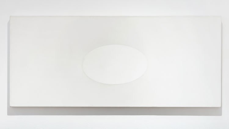 Turi Simeti. Superficie bianca con un ovale, 1988. Acrylic on shaped canvas, 23 5/8 x 55 1/8 in (60 x 140 cm). Image courtesy The Mayor Gallery.