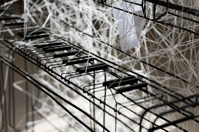 Chiharu Shiota. Beyond Time, 2018. White thread, metal piano, musical notes. Copyright VG Bild-Kunst, Bonn, 2018 and the artist. Courtesy Yorkshire Sculpture Park. Photograph © Jonty Wilde.