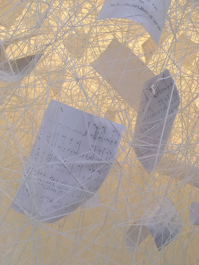 Chiharu Shiota. Beyond Time, 2018. White thread, metal piano, musical notes. Copyright VG Bild-Kunst, Bonn, 2018 and the artist. Courtesy Yorkshire Sculpture Park. Photograph © Jonty Wilde.