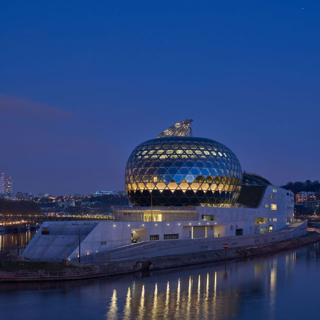 Lit up at night, the auditorium and sail glow, flagging up this new cultural quarter. Photograph: Didier Boy de la Tour.