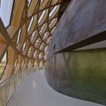 Bespoke iridescent Bisazza tiles coat the shell of the acoustic auditorium, glimmering either red or green, according to the light conditions. Photograph: Didier Boy de la Tour.