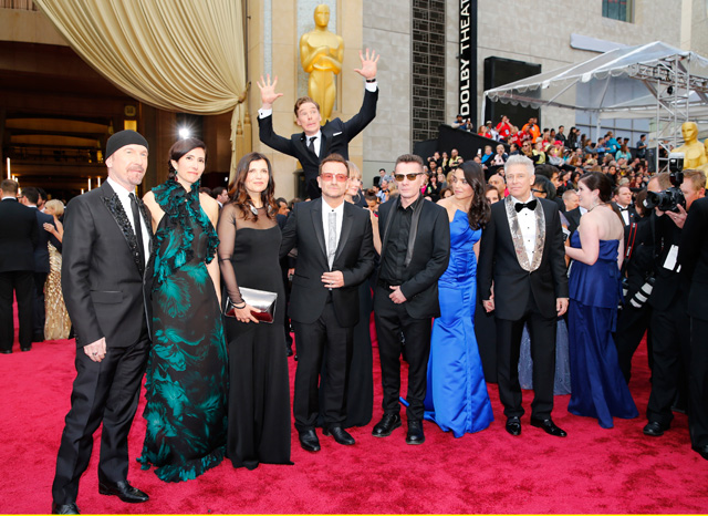 Actor Benedict Cumberbatch jumps behind U2 at the 86th Academy Awards in Hollywood, California. Courtesy Mike Blake / Reuters.