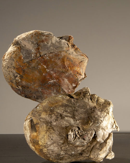 Silvia Hatzl. Heads, 2012. Earth plaster, ash, pigment, cotton, silk, paper, rust, bones, 25 x 22 x 12 cm. Courtesy Rosenfeld Porcini.