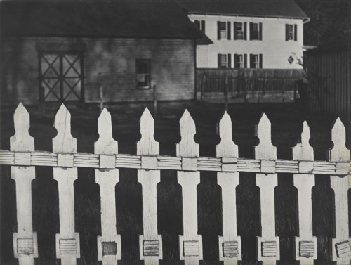 Paul Strand. White Fence, Port Kent, New York, 1916 (negative); 1945 (print). Gelatin silver print, Image and sheet: 9 5/8 × 12 13/16 in (24.5 × 32.5 cm), Philadelphia Museum of Art, The Paul Strand Retrospective Collection, 1915-1975, gift of the estate of Paul Strand, 1980. © Paul Strand Archive/Aperture Foundation.