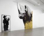 John Baldessari. Dwarf and Rhinoceros (With Large Black Shape), 1989/2013. Archival inkjet prints mounted on Lexam with inset aluminum frame, latex paint, archival inkjet print mounted on Plexiglas, dimensions variable.