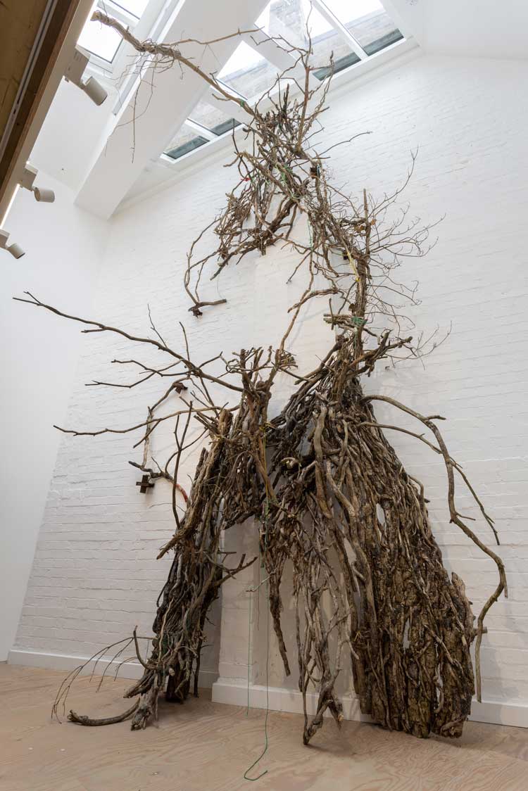 Linda Stupart. Cathedral, 2022. Assemblage of sticks and branches. Installation view, The Baroness, Mimosa House, London. Photo: Rob Harris.