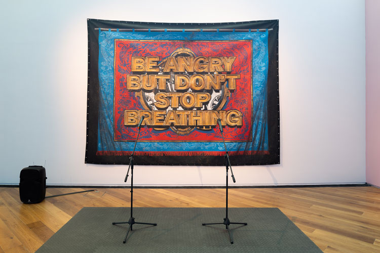 Mark Titchner. Be angry but don’t stop breathing, 2003-19.
Painted banner, matting, PA system and microphones.