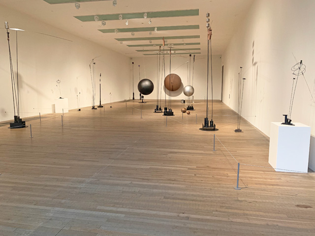 Takis. Installation view, with Musical Sphere, 1985 in the background. Tate Modern, 2019. Photo: Martin Kennedy.