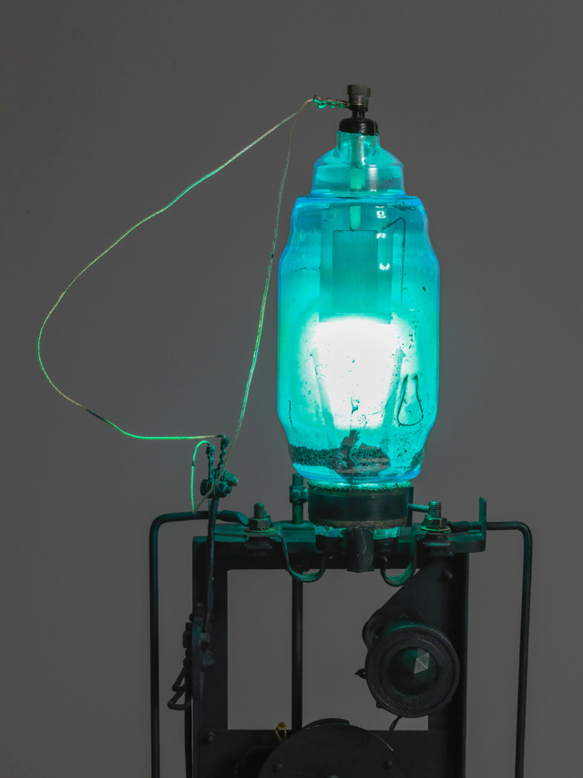 Takis. Télélumière No. 4 (detail), 1963–4. Iron machine parts, light bulbs, wood, brass, steel, electromagnet, string and paint, 108 × 30 × 32 cm, 30 x 60 cm approx. Tate. Purchased with assistance from Tate International Council, Tate Members, Tate Patrons and with Art Fund support 2019. © ADAGP, Paris and DACS, London 2019. Photo: © Tate (Andrew Dunkley and Mark Heathcote).