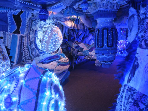 Joana Vaconselos. (Installation view 2) Decommissioned ferry, exterior covered in typical Portuguese blue and white tiles showing a Lisbon panorama. Ship's hold transformed into a fuzzy blue womb of crochet and fairy lights, with padded walls and giant pompoms hanging from above. Photograph: Dorothy Feaver.