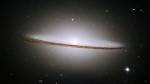 The Sombrero Galaxy (M104). Hubble Space Telescope, 2003. Advanced Camera for Surveys (ACS). Like other spiral galaxies, the Sombrero consists of a flat disc of stars surrounding a fatter central ‘bulge’. However, here this central core of stars extends out to encompass the whole of the disc in a halo of stars. Like most galaxies, the heart of the Sombrero conceals a dark secret: a super-massive black hole containing as much matter as a billion Suns. © NASA and the Hubble Heritage Team (STScI/AURA): http://hubblesite.org/gallery/album/pr2003028a/
