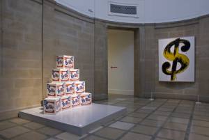 Andy Warhol. <em>Brillo Boxes</em> (1968) and <em>Dollar Sign</em> (1982).