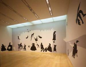 Kara Walker, <i>The Hot Black Road to Freedom, a double-dixie two-step 
        (Detail)</i>, 2005. Cut paper and adhesive on wall. Collection of the 
        artist and Brent Sikkema, New York. Installation view: The World is a 
        Stage: Stories Behind Pictures. Photo: Kioku Keizo. Photo courtesy: Mori 
        Art Museum