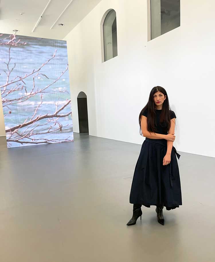 Selma Selman in front of Crossing The Blue Bridge, 2024, Galleria d’Arte Moderna e Contemporanea di Bergamo. Photo: Veronica Simpson.